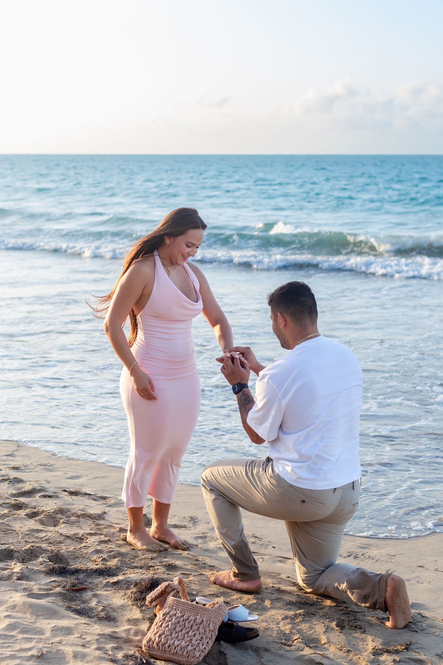 Man proposing to a woman at the beach in Isla Verde, Carolina, Puerto Rico.