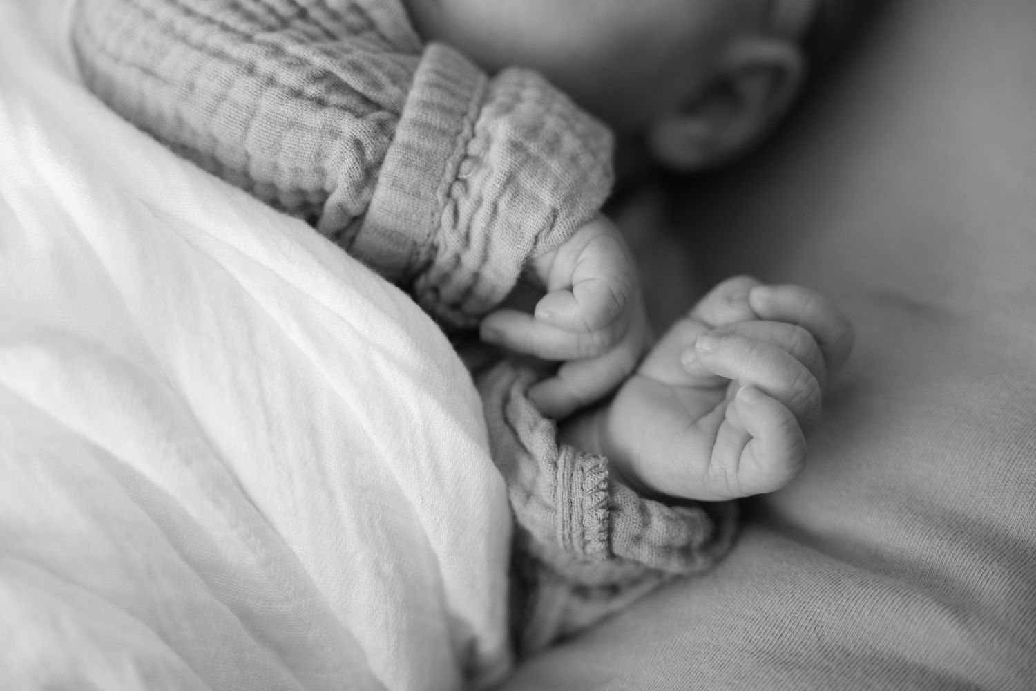 detail photo of newborn baby's hands during in home lifestyle newborn session in lake elmo, mn