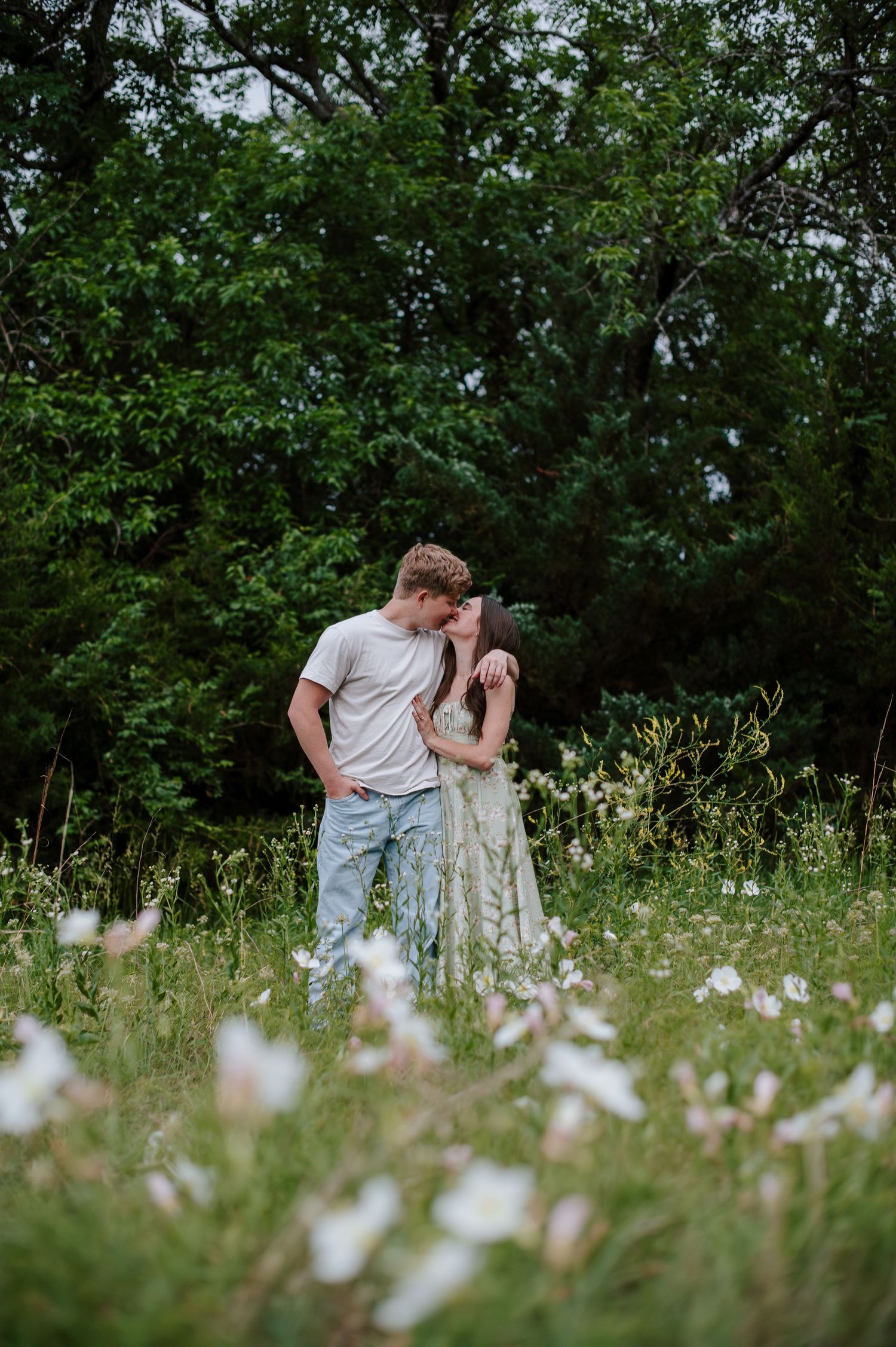 Wichita KS outdoor engagement photos in nature location Andover, couple photos in field with flowers, small elopement wedding photographer
