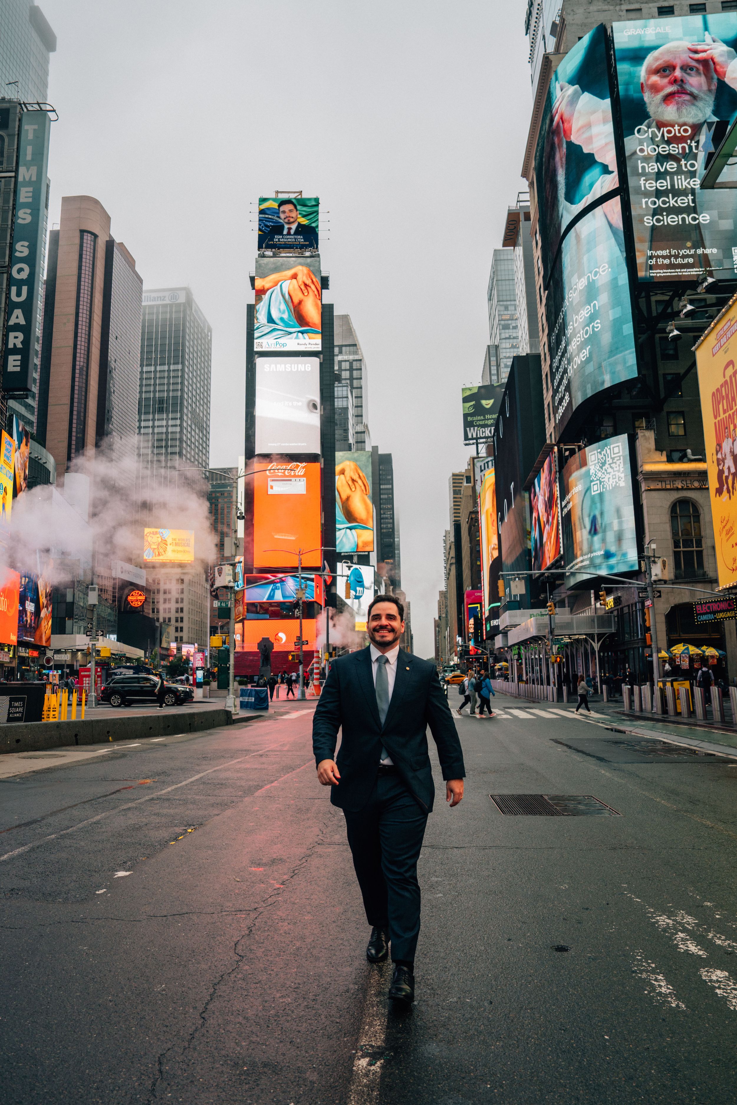 Man in suit walking confidently through Times Square NYC with colorful billboards and skyscrapers in background.