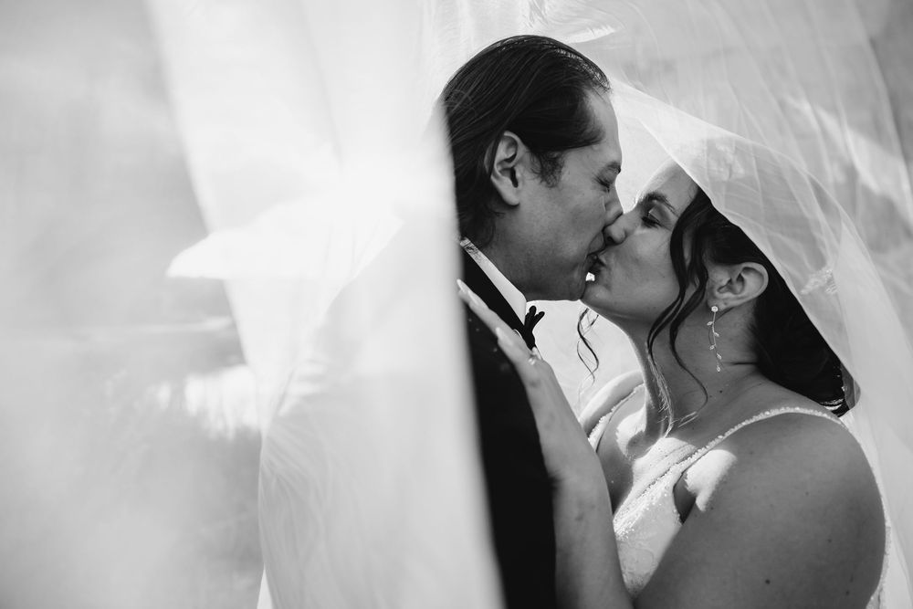 A romantic black and white photo series showing intimate moments between a couple in loving embraces.