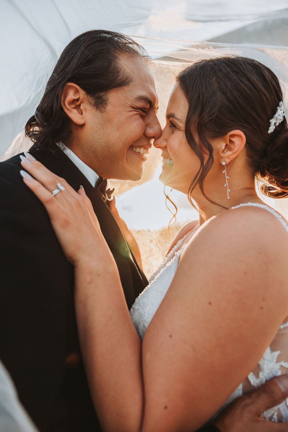 A romantic sunset wedding photoshoot showing intimate close-up moments between newlyweds against golden sunlight.