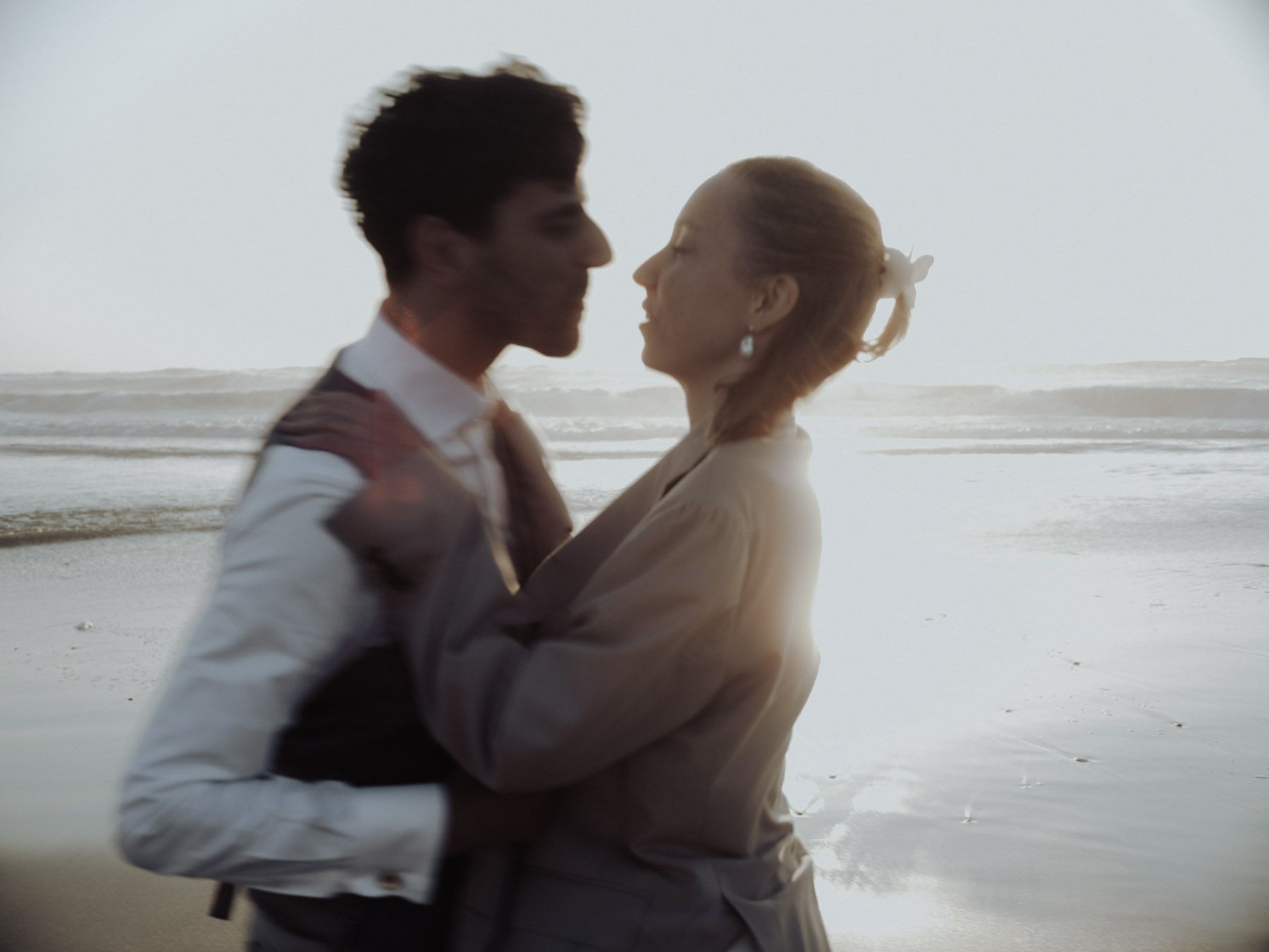 wedding couple embracing on the beach in porto portugal