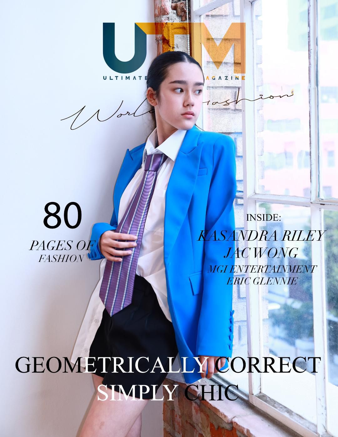 Fashion magazine cover featuring a model in a bright blue blazer, white shirt and purple tie against a window backdrop.