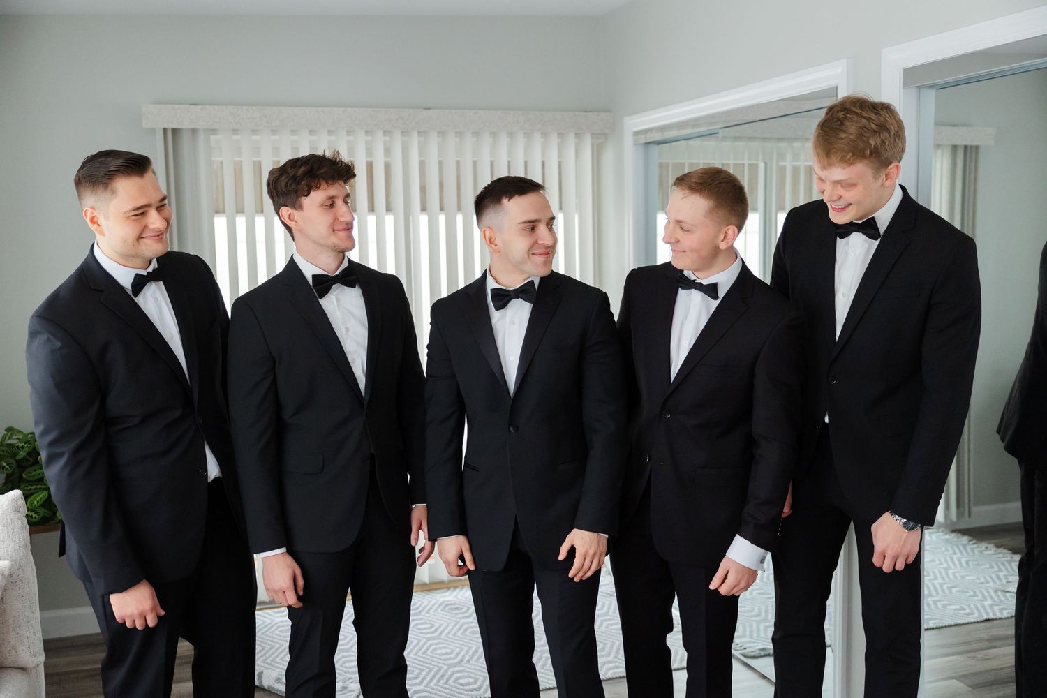 Groom and groomsmen laughing captured by Tom Forrest Photography from Hudson, Ohio.