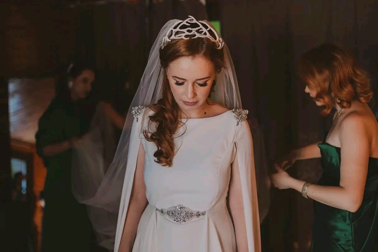 A bride in a classic white wedding gown walks gracefully during her wedding celebration.