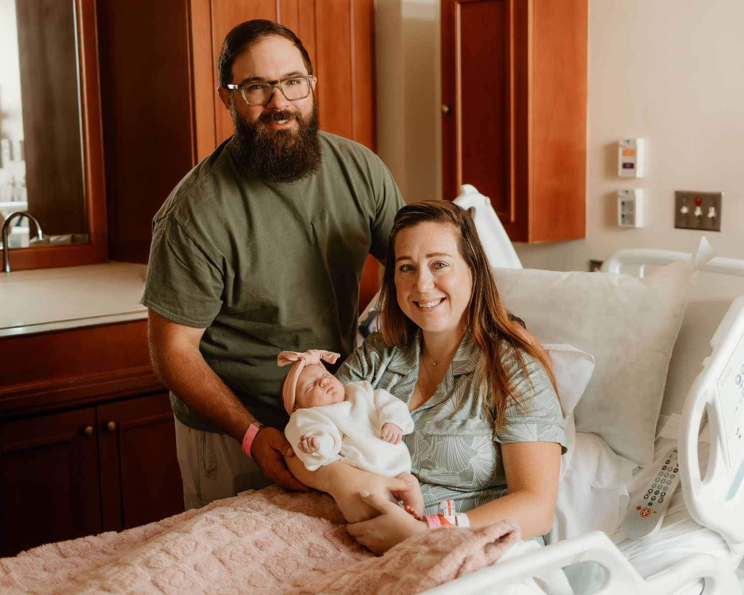 Tender moments in hospital room with new family.
