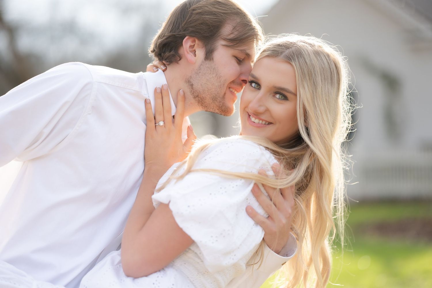 A romantic wedding moment captured through a delicate veil as a couple embraces during their special day.
