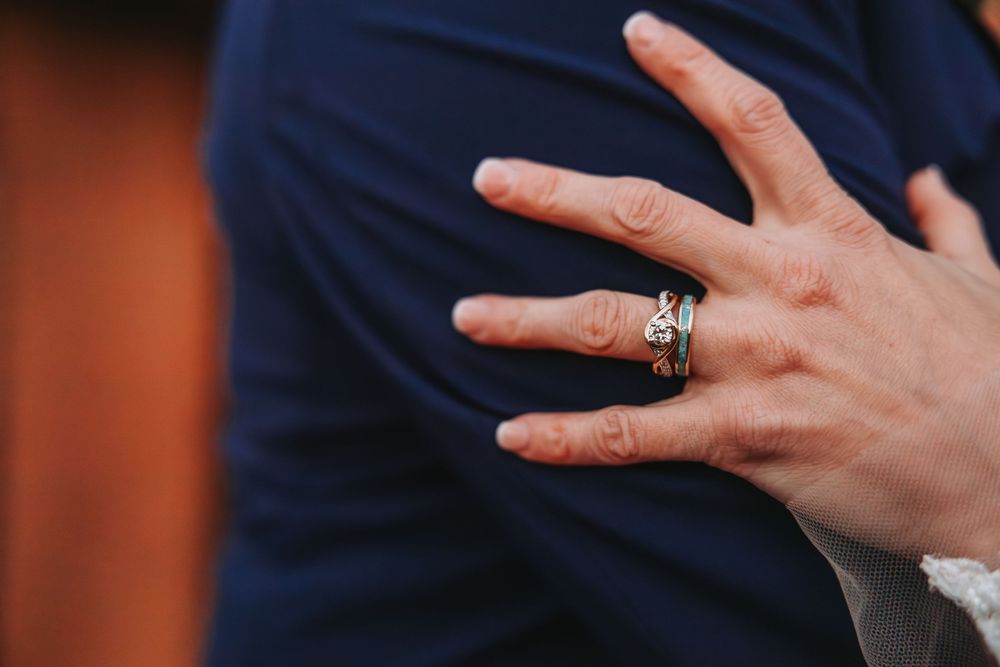 Close-up of hands gesturing against a dark background in a sequence of expressive movements.