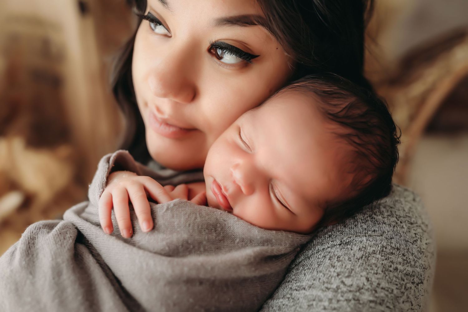 A tender moment between parent and child as they embrace in soft natural lighting.