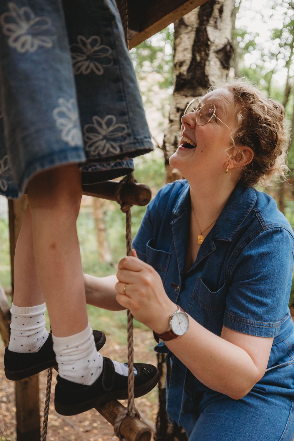 A sequence of photos showing someone in a denim jacket laughing while looking up at someone's feet in white socks.