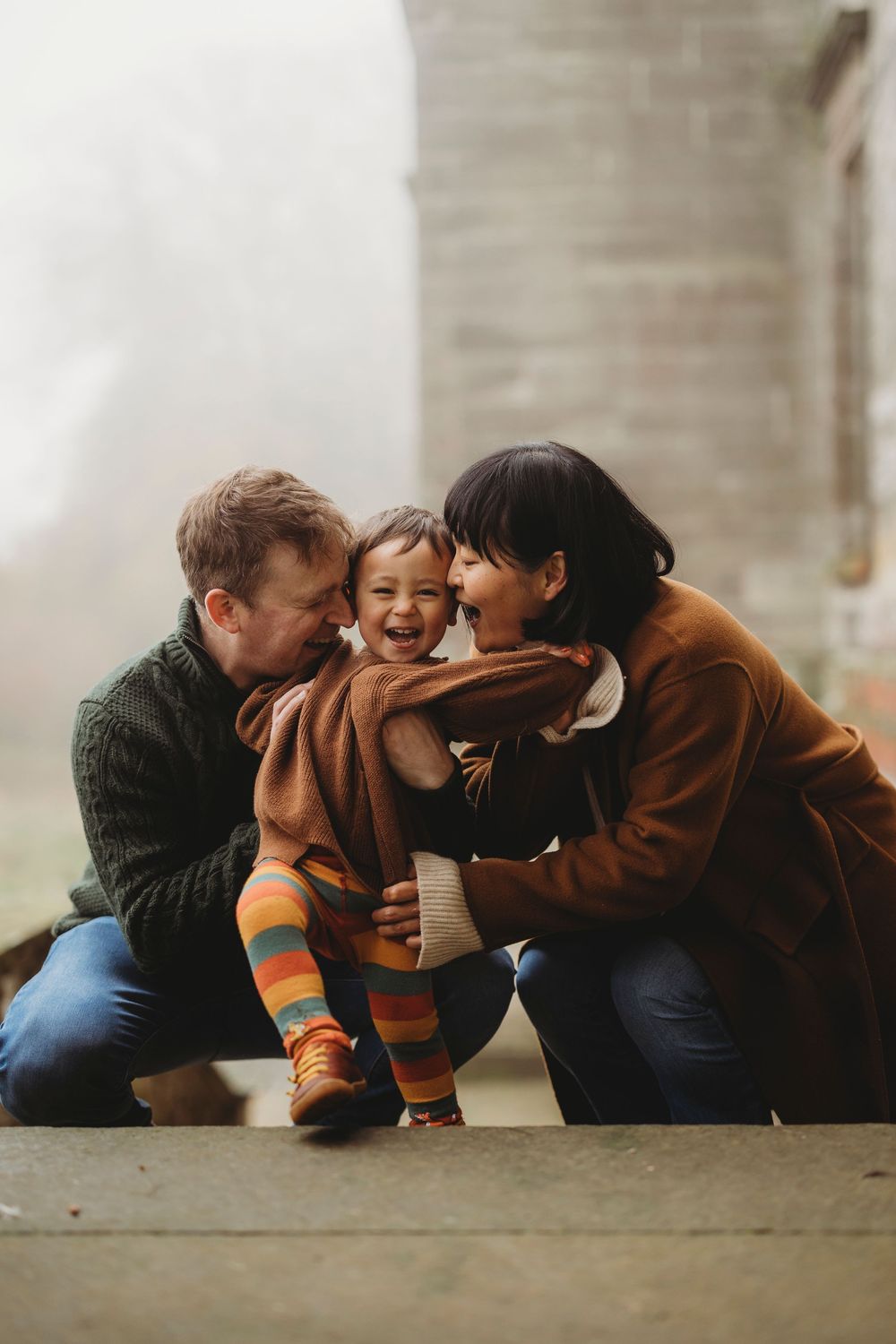 Three candid moments showing people lying down and sharing joyful laughter together on a concrete surface.