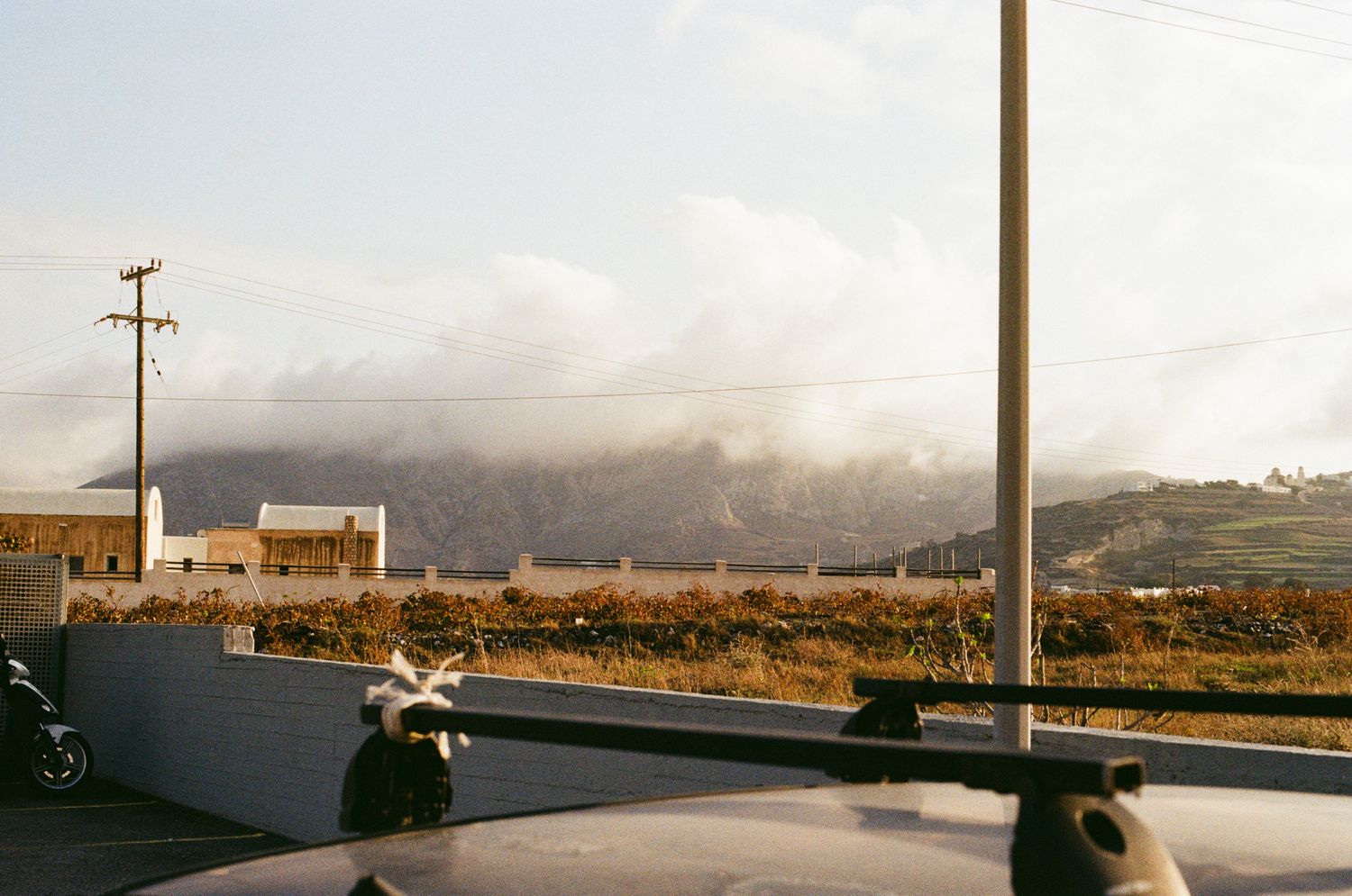 A panoramic sequence of desert landscape photos showing mountains, power lines, and buildings under a cloudy sky.