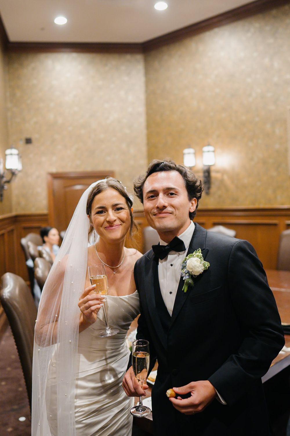 Wedding celebration moments in an elegant indoor venue with warm lighting and formal attire.