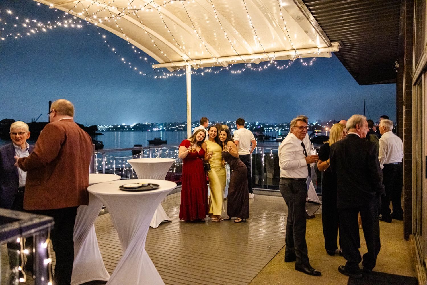 Panoramic view of a wedding reception venue in Woolwich with guests dancing under soft lighting and decorative elements.