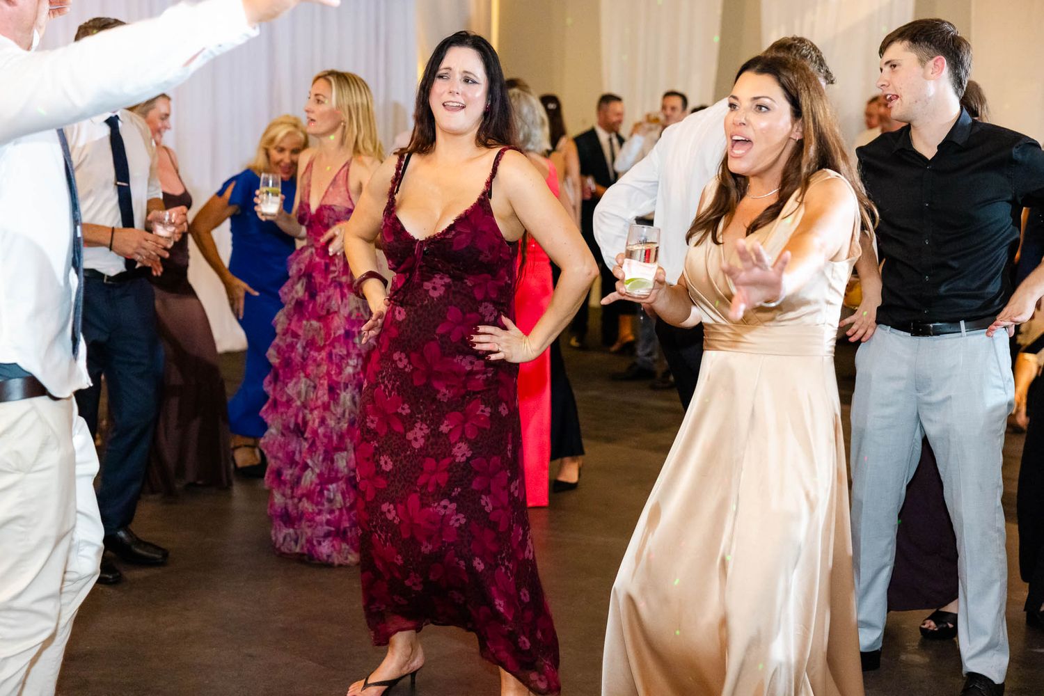 Wedding guests dance and celebrate together on the dance floor during a reception.