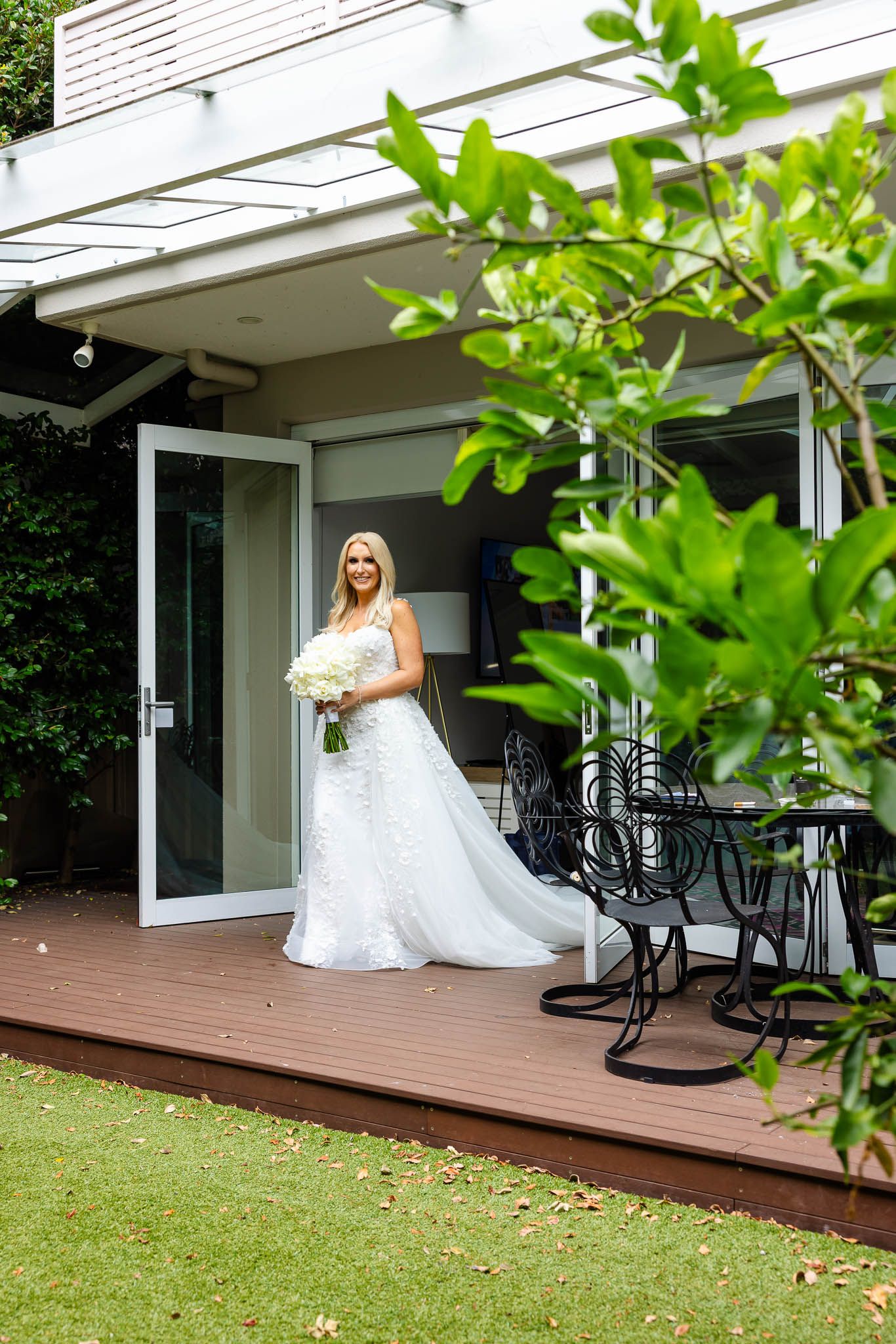 A sequence of photos showing a bride in a white wedding dress on a wooden deck with lush green foliage in the background.