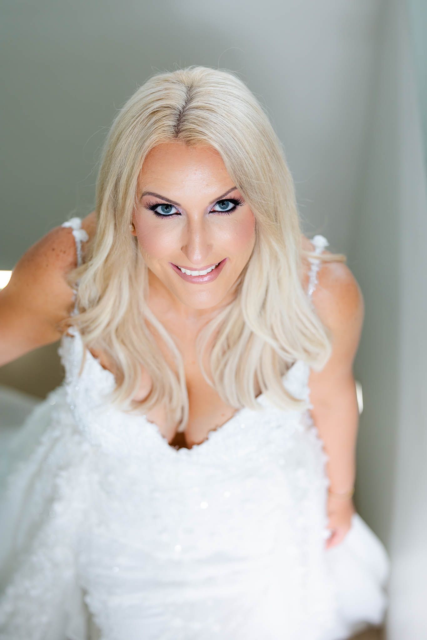 A series of bridal portraits showing a woman in a white dress with platinum blonde hair against a light background.