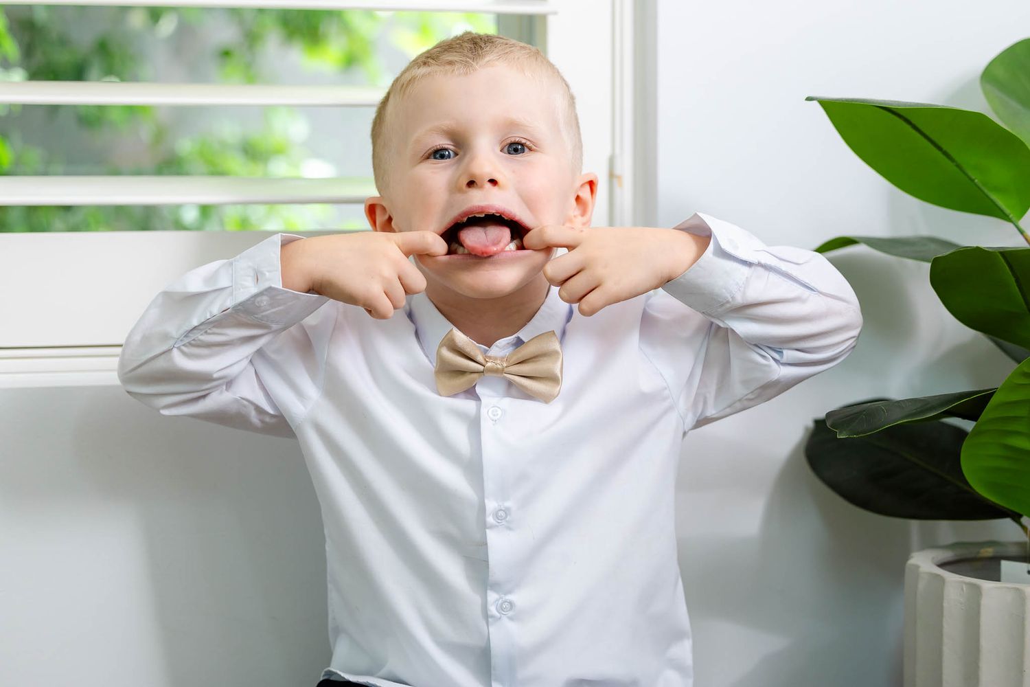 A series of six photos showing someone in a white shirt making silly expressions and poses against a green leafy background.