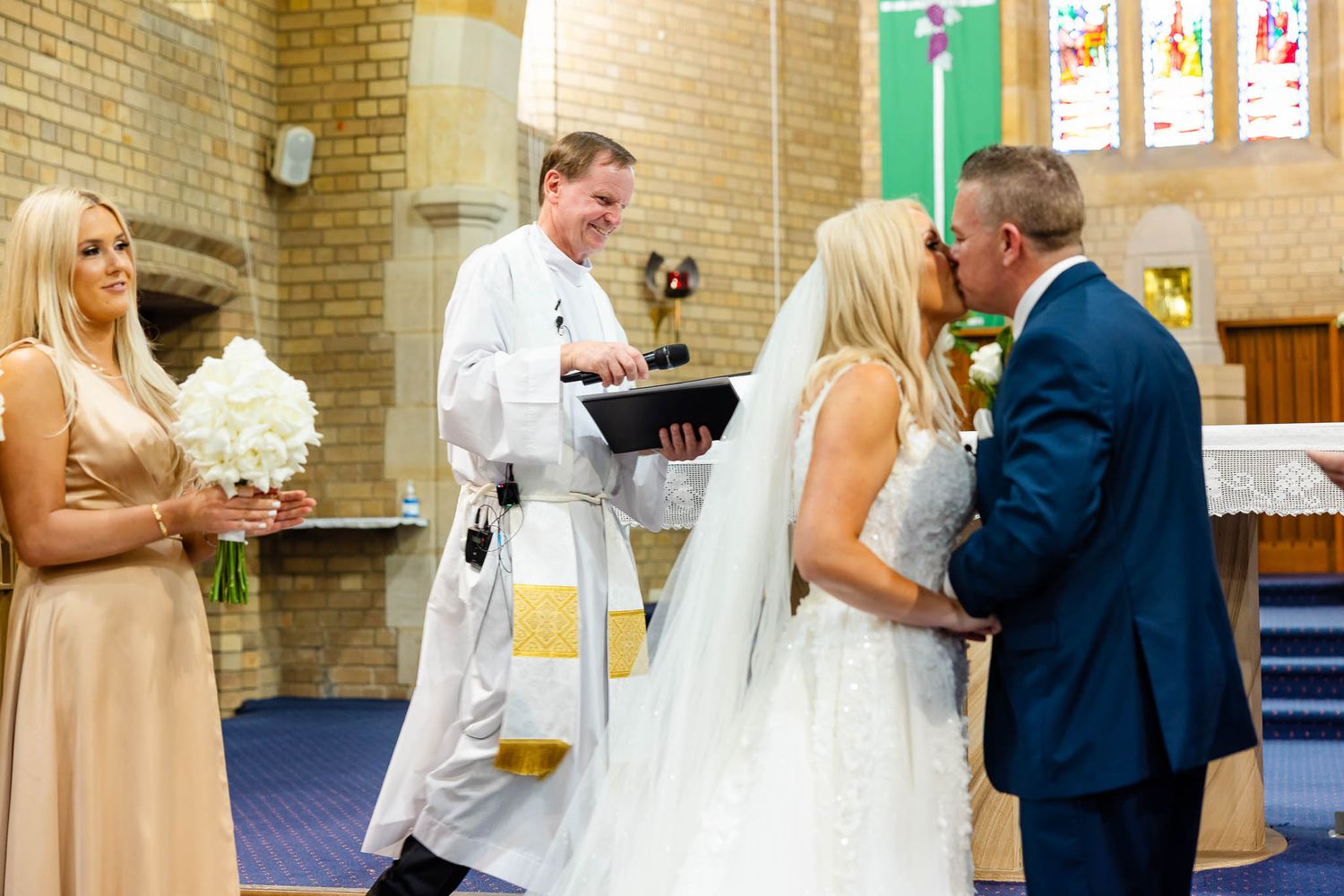 A romantic wedding montage showing couples sharing special moments during their ceremony in a church setting.