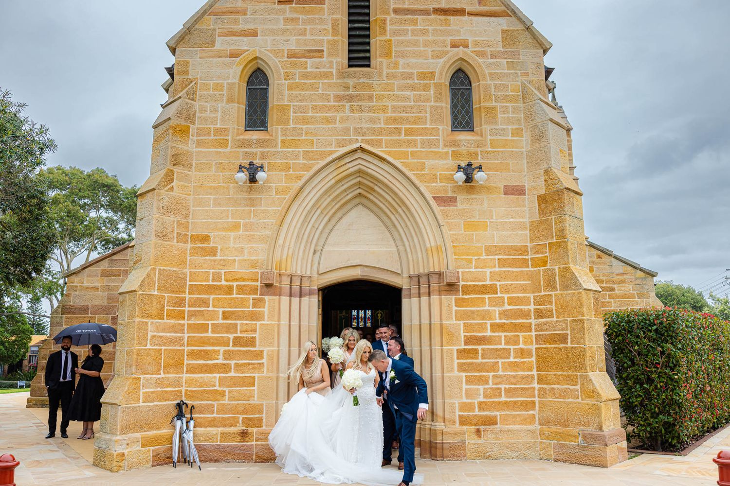 A series of wedding photographs showing couples outside a sandstone church with Gothic arched windows and doorways.