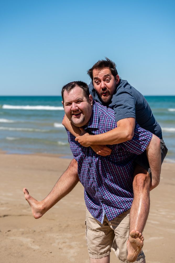 Candid family photography showing joyful moment between siblings.