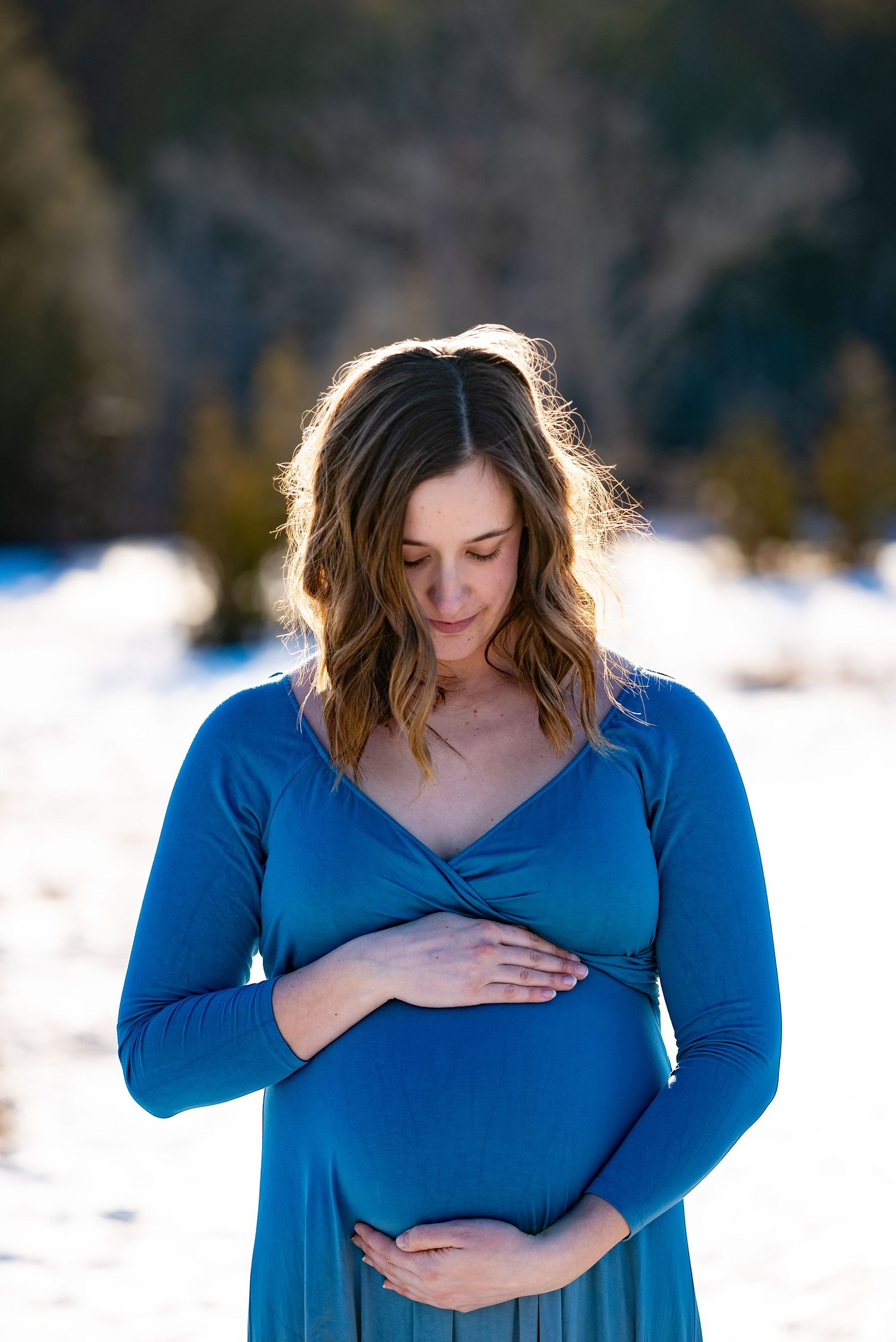 Outdoor maternity photography session during golden hour.