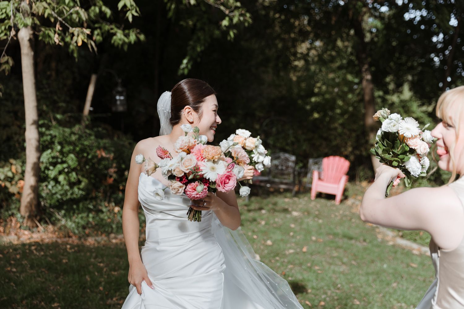Candid moment of the bride and bridesmaid laughing, showcasing multi-cultural connection and joy. Toronto wedding photography.