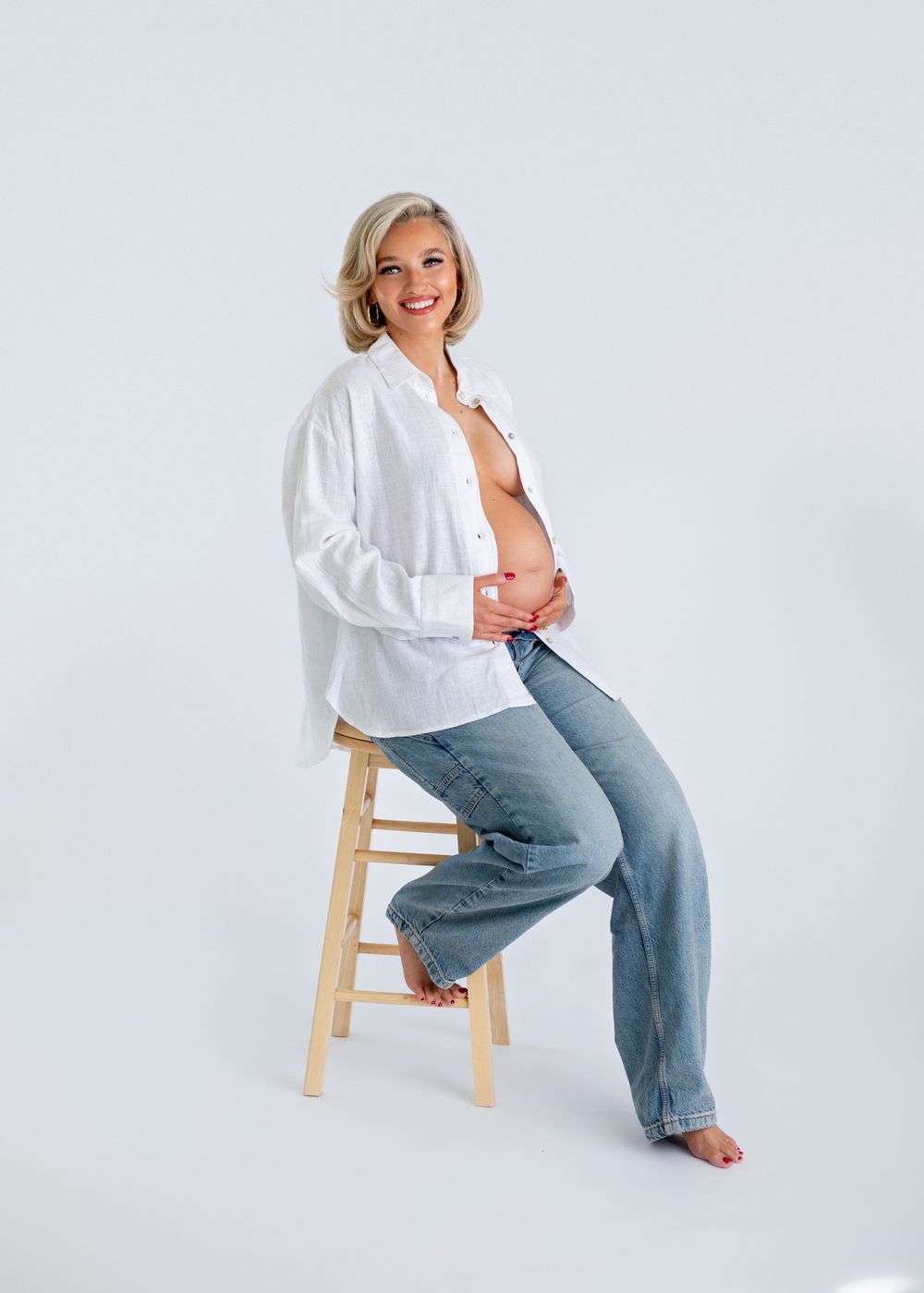 A person in a white shirt and jeans poses on a wooden stool against a white background in progressive shots.