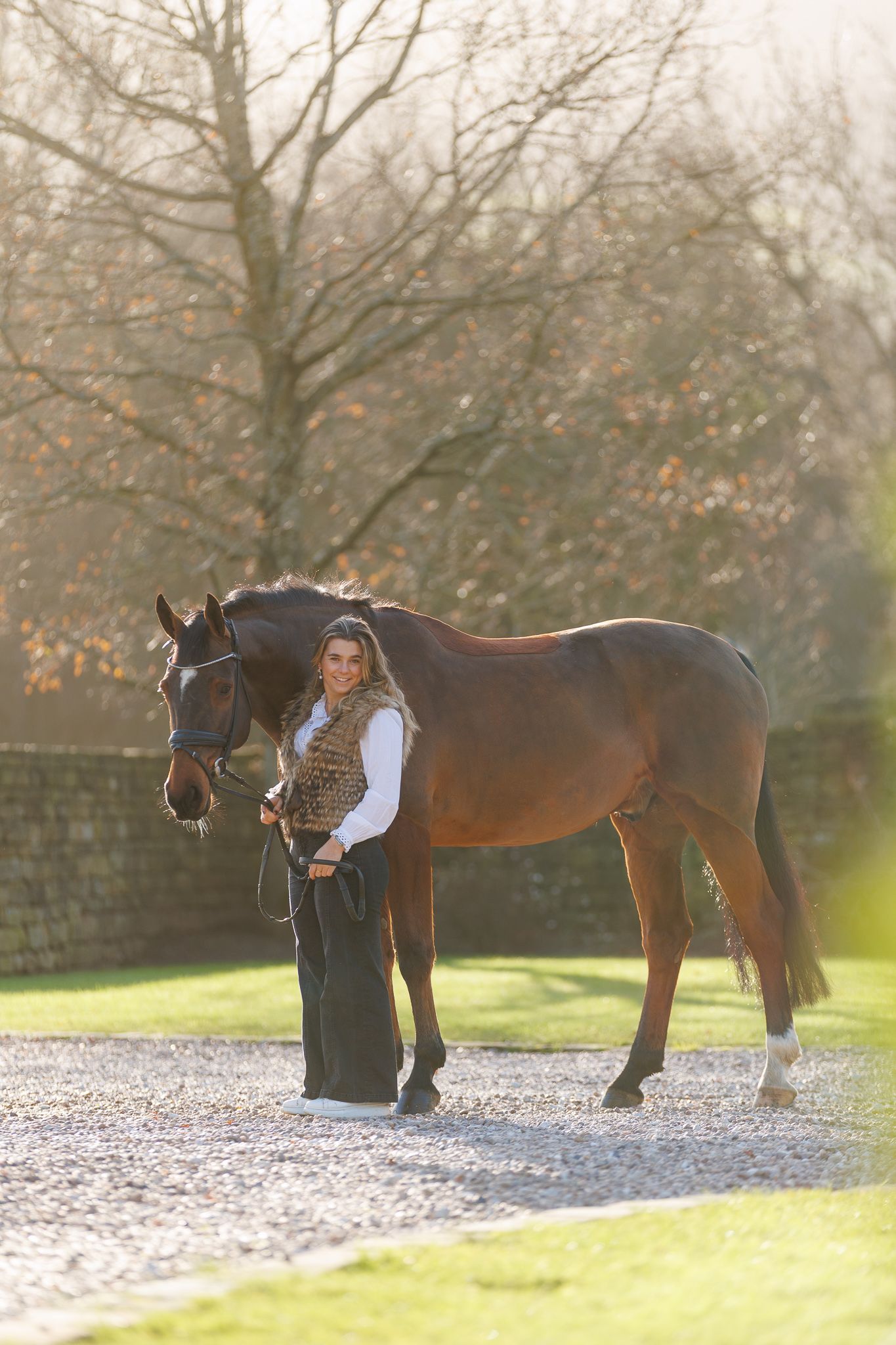 A series of photos showing a person in a white polka dot shirt with a black horse in a golden autumn field.
