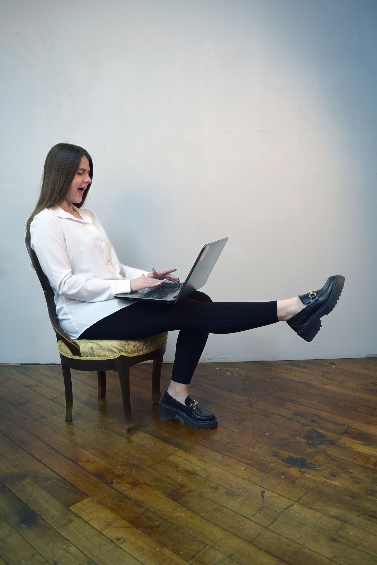 A series of photos showing someone wearing a red crop top and jeans posing against a gray studio backdrop.