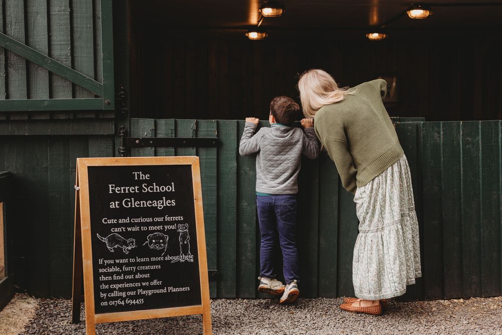 A chalkboard sign displayed in a rustic setting with wooden panels in the background.