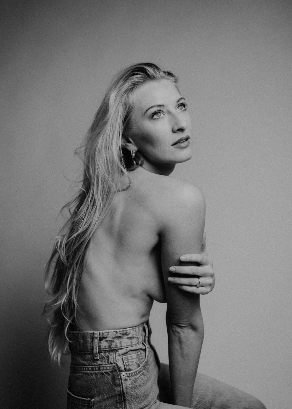 Artistic black and white portrait of a woman with flowing blonde hair in denim.