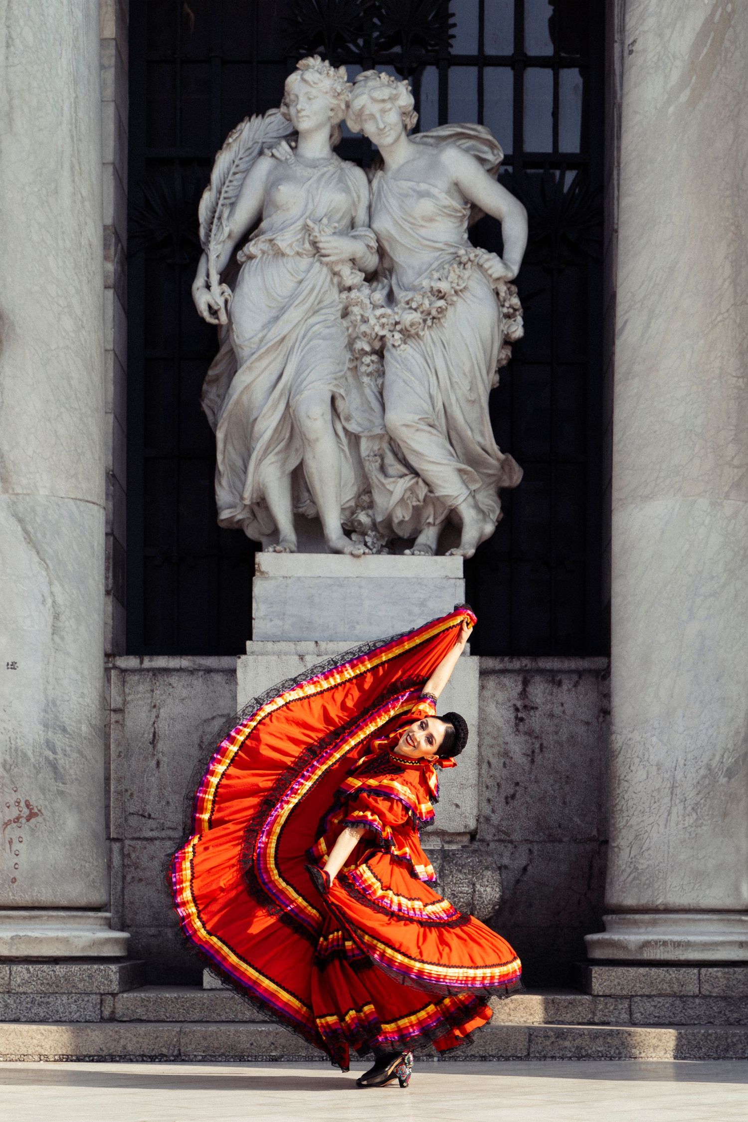 Ballet Folklórico dancer showcasing traditional costume outside Palacio de Bellas Artes