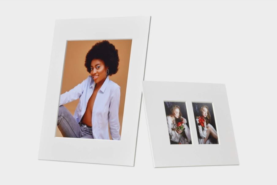 Three polaroid-style photos arranged on a white surface showing artistic portrait poses against contrasting backgrounds.