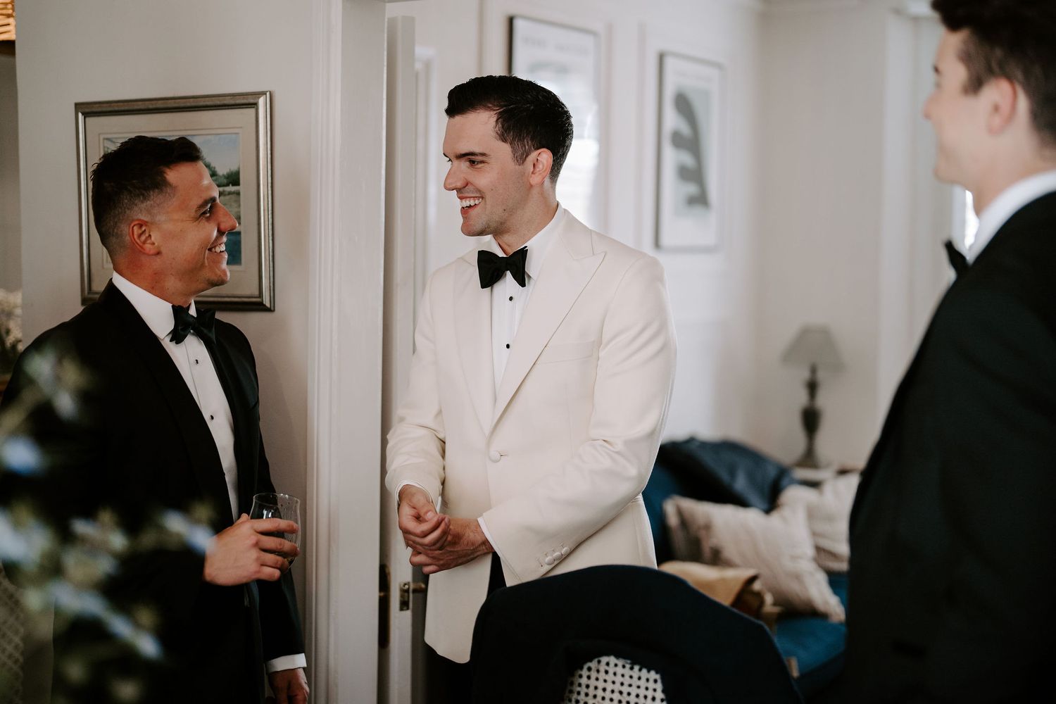 groom laughing with groomsmen at hamswell house wedding in bath