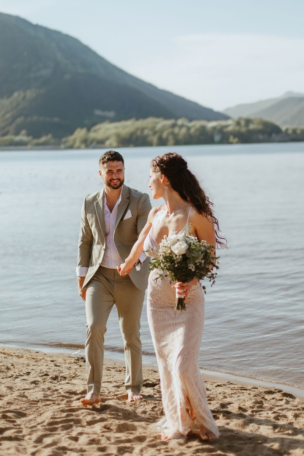 Bride and groom on their wedding day on the beach in Québec, captured in soft natural light by a professional wedding photographer at sunset