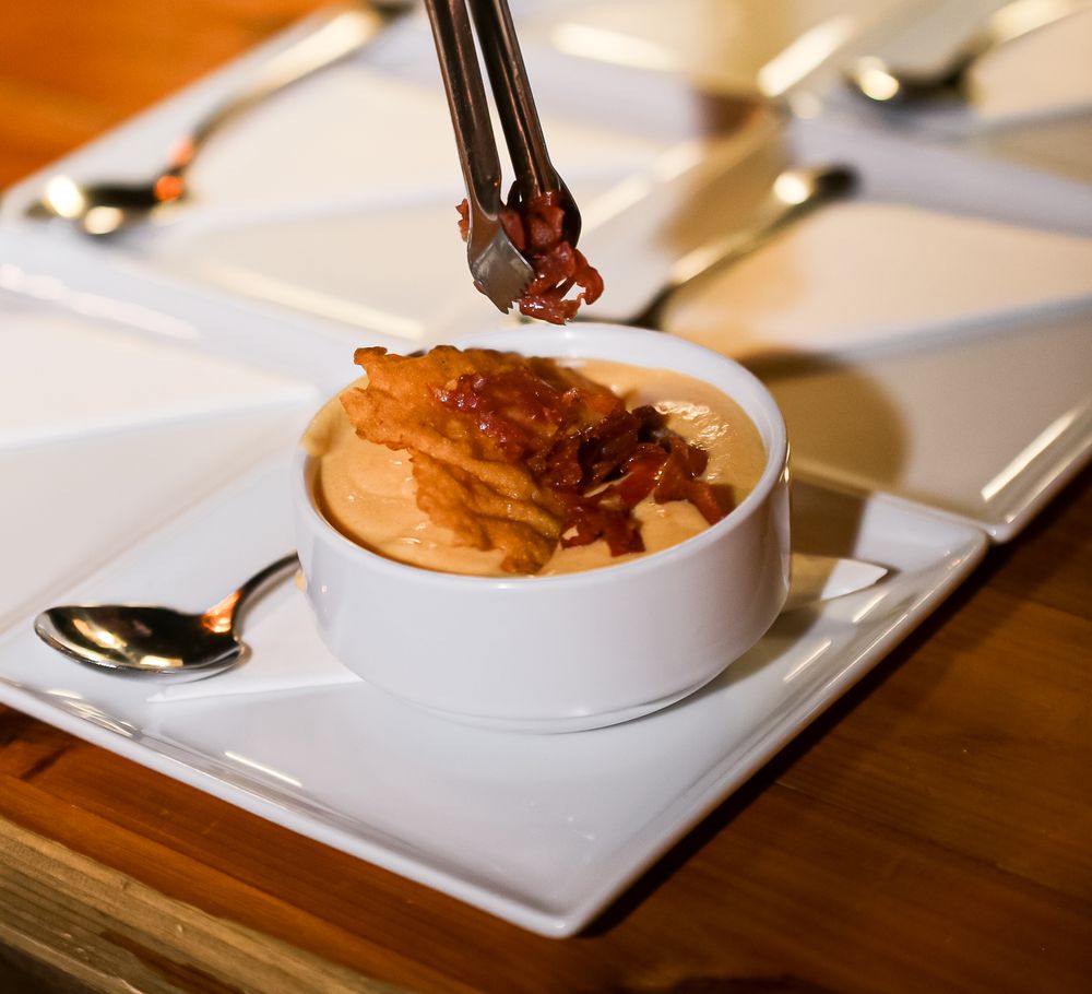 Fine dining entrees served on white plates with elegant presentation.
