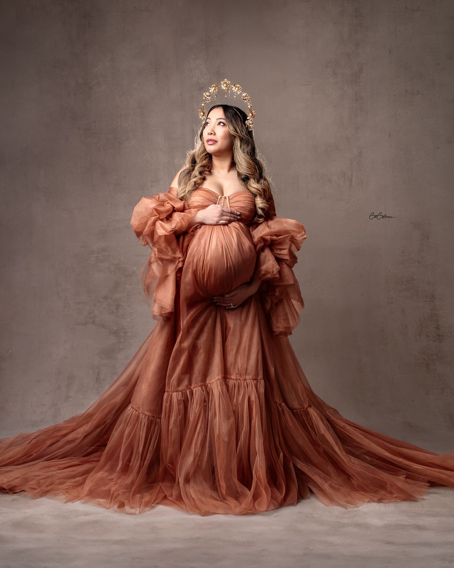 Sydney maternity photographer: mum in a bespoke bronze gown against a unique beige handprinted backdrop.