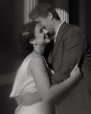 Intimate black and white portrait of a couple sharing a tender moment.