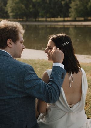 Intimate moment between couple sitting by reflecting pool in Washington DC.