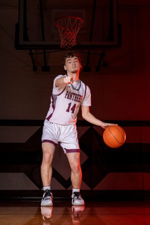 Individual basketball players pose confidently in uniform, capturing strength, focus, and determination in dynamic sports portraits.