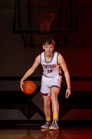 Individual basketball players pose confidently in uniform, capturing strength, focus, and determination in dynamic sports portraits.