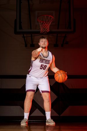 Individual basketball players pose confidently in uniform, capturing strength, focus, and determination in dynamic sports portraits.