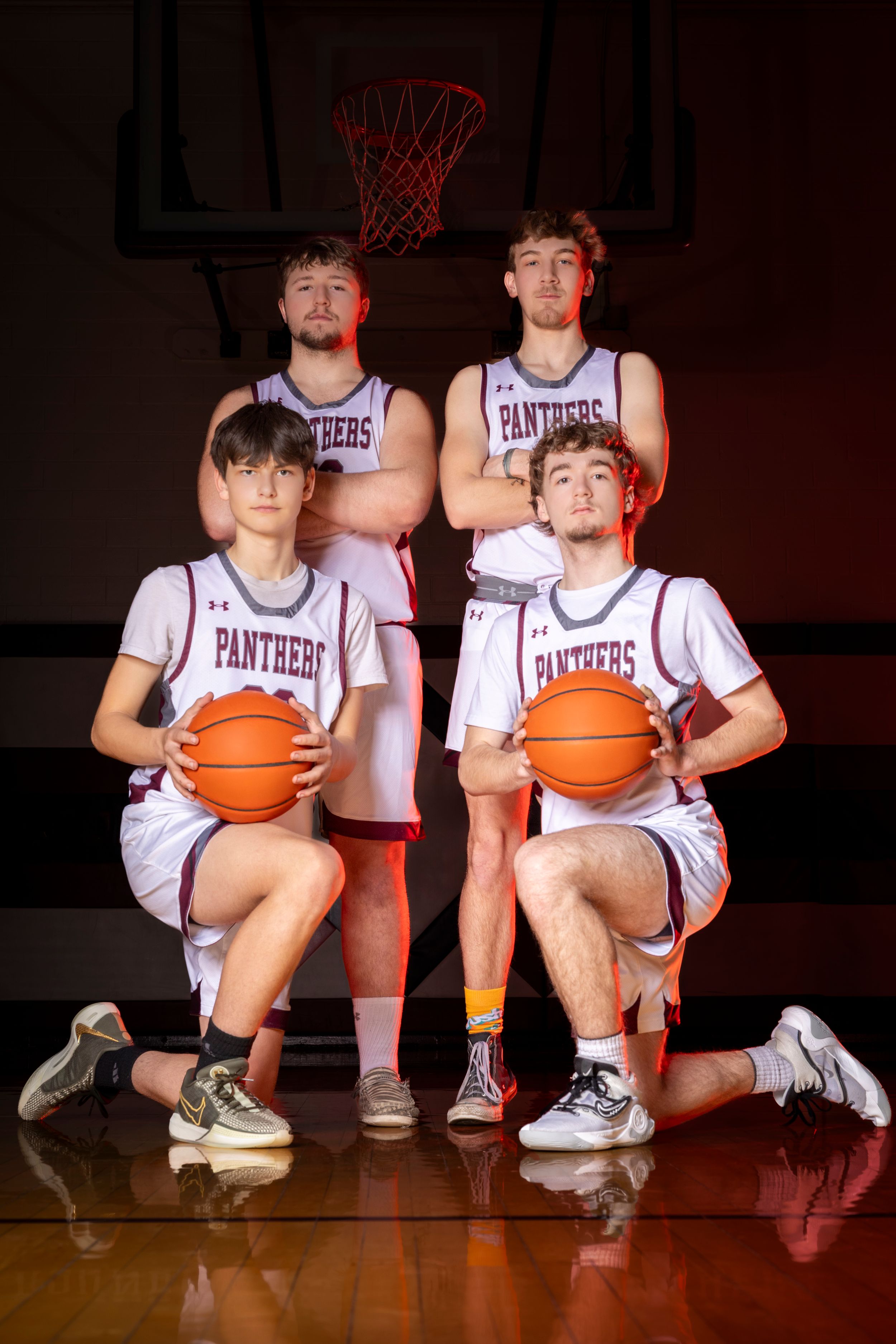 A small basketball group poses for a sharp, confident portrait session, showcasing unity and team pride with focused expressions.
