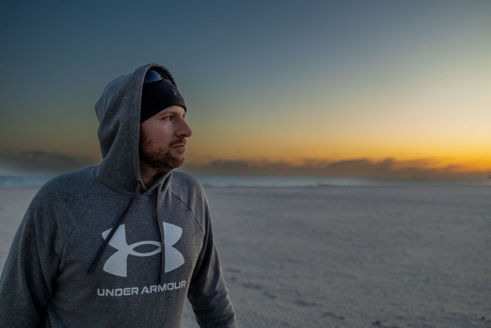Under Armour hoodie against dramatic sunset sky.
