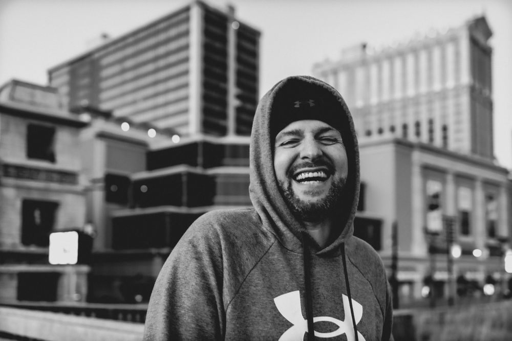 Urban streetscape with Under Armour hoodie in black and white.