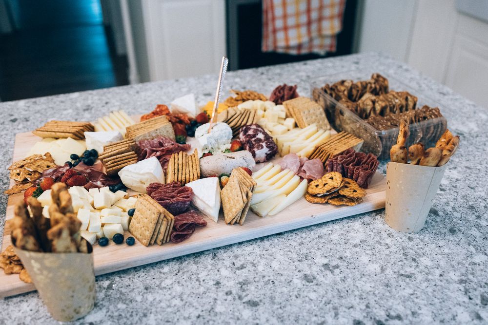 Elegant dessert platter with assorted pastries and treats on granite countertop.