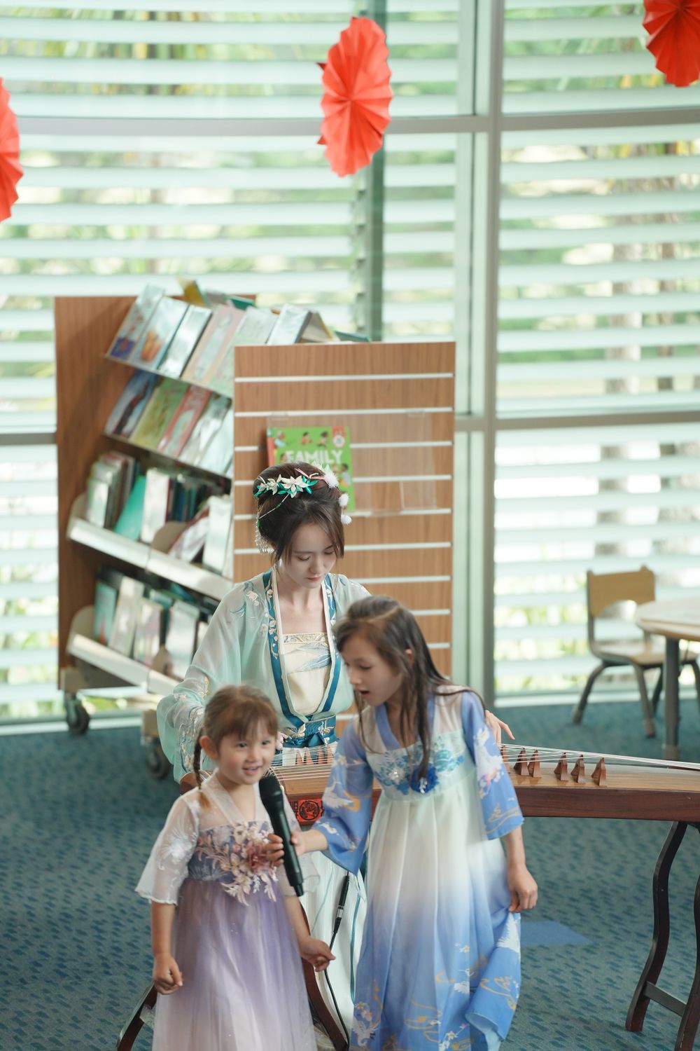 Library New Year event photography featuring a beautiful traditional Hanfu Guzheng performance, by an Auckland photographer.