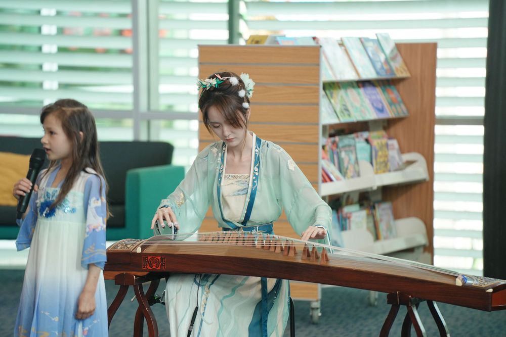 Library New Year event photography featuring a beautiful traditional Hanfu Guzheng performance, by an Auckland photographer.